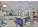 Spacious open concept kitchen with island, stainless steel appliances, and dining area at 13728 Artesa Bell Dr, Riverview, FL 33579