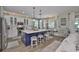Bright kitchen with a large island, white cabinets, pendant lighting, and breakfast nook at 13728 Artesa Bell Dr, Riverview, FL 33579