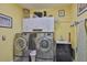Functional laundry room with washer, dryer, cabinets, and a utility sink for added convenience at 13728 Artesa Bell Dr, Riverview, FL 33579