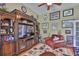 Inviting living room with large entertainment center and leather armchairs at 13728 Artesa Bell Dr, Riverview, FL 33579