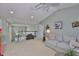 Open living area with plush carpeting, vaulted ceilings, neutral paint and comfortable seating at 13728 Artesa Bell Dr, Riverview, FL 33579