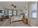Relaxing main bedroom featuring a king-sized bed, ceiling fan, and natural light at 13728 Artesa Bell Dr, Riverview, FL 33579