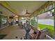Extended, covered patio ideal for outdoor living and entertaining with a view of the landscaped backyard at 13728 Artesa Bell Dr, Riverview, FL 33579