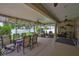 Relaxing screened patio featuring an outdoor dining area and comfortable seating, perfect for enjoying the weather at 13728 Artesa Bell Dr, Riverview, FL 33579