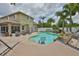 Backyard with a sparkling pool surrounded by palm trees and lounge chairs with outdoor storage at 13728 Artesa Bell Dr, Riverview, FL 33579