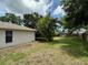 Lush backyard with mature trees and landscaping, creating a private oasis at 1548 Foxboro Dr, Palm Harbor, FL 34683