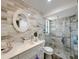 Modern bathroom featuring a glass-enclosed shower, stylish vanity, and chic wall tiles at 1548 Foxboro Dr, Palm Harbor, FL 34683