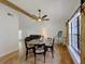 Dining room with wood floors, shiplap wall, decorative ceiling fan, and natural light at 1548 Foxboro Dr, Palm Harbor, FL 34683