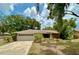One-story home with a well-manicured lawn, and a two-car garage at 1548 Foxboro Dr, Palm Harbor, FL 34683