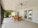Covered patio with seating and ceiling fan, ideal for outdoor dining and relaxing at 1548 Foxboro Dr, Palm Harbor, FL 34683