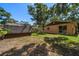 This backyard has a large shed and is surrounded by lush green trees at 15623 Morgan St, Clearwater, FL 33760