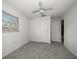 This bedroom features white walls, grey carpeting, a window and two closets at 15623 Morgan St, Clearwater, FL 33760