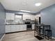 Updated kitchen features white cabinets, stainless steel appliances, and casual dining area at 15623 Morgan St, Clearwater, FL 33760
