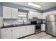 Bright kitchen with white cabinetry, stainless steel appliances, and modern fixtures at 15623 Morgan St, Clearwater, FL 33760