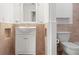 Small bathroom featuring vanity sink with storage and decorative tile at 15636 Morning Dr, Lutz, FL 33559