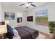 Inviting bedroom with an ensuite, large window and a mounted TV at 15636 Morning Dr, Lutz, FL 33559