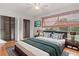Cozy bedroom with a king bed, large window, and walk-in closet at 15636 Morning Dr, Lutz, FL 33559