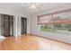 Sun-filled bedroom with hardwood floors, a ceiling fan and large window at 15636 Morning Dr, Lutz, FL 33559