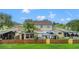 Charming home exterior featuring a fenced backyard, gazebo, and screened-in porch, perfect for outdoor living and entertaining at 15636 Morning Dr, Lutz, FL 33559
