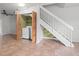 Convenient laundry area located near the staircase with shelving and bi-fold doors at 15636 Morning Dr, Lutz, FL 33559