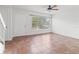 Bright living room showcasing neutral decor, tile flooring, and large window at 15636 Morning Dr, Lutz, FL 33559
