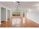 Spacious living room featuring gleaming hardwood floors, ceiling fan, and natural light at 15636 Morning Dr, Lutz, FL 33559