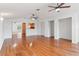 Open-concept living room with hardwood floors connecting to the kitchen and dining areas at 15636 Morning Dr, Lutz, FL 33559