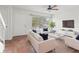Bright living room with tile flooring, ceiling fan, large window and modern white furniture set at 15636 Morning Dr, Lutz, FL 33559
