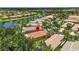 Aerial view of community featuring lush trees, lakes and mature landscaping at 15744 Crystal Waters Dr, Wimauma, FL 33598