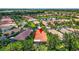Aerial view showcases the community, lake, and mature trees at 15744 Crystal Waters Dr, Wimauma, FL 33598