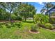 Scenic backyard featuring a well-manicured lawn and mature trees at 15744 Crystal Waters Dr, Wimauma, FL 33598