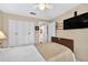 Cozy bedroom featuring large closets and a flat-screen TV on the wall at 15744 Crystal Waters Dr, Wimauma, FL 33598