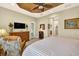 Tastefully decorated bedroom with plantation shutters, a dresser, and a view of a door to the bathroom at 15744 Crystal Waters Dr, Wimauma, FL 33598