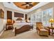 Bright bedroom featuring large windows with plantation shutters, plus wicker furniture at 15744 Crystal Waters Dr, Wimauma, FL 33598