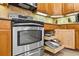 Stainless steel oven with additional storage and tiled backsplash at 15744 Crystal Waters Dr, Wimauma, FL 33598