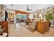 Comfortable living room flows to a screened lanai, blending indoor/outdoor living with stylish furnishings and natural light at 15744 Crystal Waters Dr, Wimauma, FL 33598