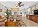 Spacious living room boasts elegant decor, opening to the dining area and featuring recessed lighting and a decorative ceiling at 15744 Crystal Waters Dr, Wimauma, FL 33598
