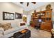 Beautiful home office with an antique hutch desk and a sitting area with sofa at 15744 Crystal Waters Dr, Wimauma, FL 33598