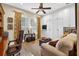 Comfortable home office with white built-in storage cabinets, a ceiling fan, and a window with shutters at 15744 Crystal Waters Dr, Wimauma, FL 33598