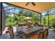Screened patio with table, ceiling fan, and decorative heron at 15744 Crystal Waters Dr, Wimauma, FL 33598