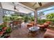 Spacious screened-in patio features brick flooring and comfortable wicker seating at 15744 Crystal Waters Dr, Wimauma, FL 33598