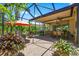 Covered and screened patio with brick flooring and comfortable furniture at 15744 Crystal Waters Dr, Wimauma, FL 33598