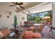 Inviting screened patio with brick floors, ceiling fans, and comfortable wicker furniture at 15744 Crystal Waters Dr, Wimauma, FL 33598