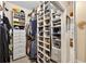 Spacious walk-in closet with custom shelving and drawers, offering ample storage and organization at 15744 Crystal Waters Dr, Wimauma, FL 33598
