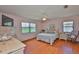 Charming bedroom featuring laminate floors, two windows for ample light, and soft color palette at 2417 Locksley St # 229, Sun City Center, FL 33573