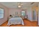 Bedroom features laminate floors, two windows for ample light, a ceiling fan, and connected bathroom at 2417 Locksley St # 229, Sun City Center, FL 33573