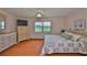 Bedroom featuring laminate floors, two windows for ample light, a ceiling fan and soft color palette at 2417 Locksley St # 229, Sun City Center, FL 33573