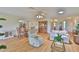 Spacious living room and dining area featuring hardwood floors, ceiling fan, and ample natural light at 2417 Locksley St # 229, Sun City Center, FL 33573