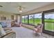 Bright sunroom with panoramic windows, tile flooring, and cozy seating at 2417 Locksley St # 229, Sun City Center, FL 33573