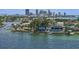 Waterfront home with dock, lush greenery, and beautiful city skyline backdrop at 2650 W Bay Isle Se Dr, St Petersburg, FL 33705